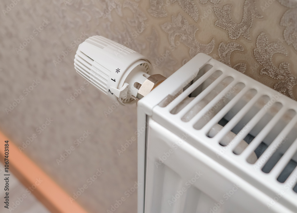 Temperature control knob on room battery. Metal radiator with individual control. heating system, energy crisis, energy saving, heat saving, heating season. top view Temperature control knob on room battery. Metal radiator with individual control. heating system, energy crisis, energy saving, heat saving, heating season. top view