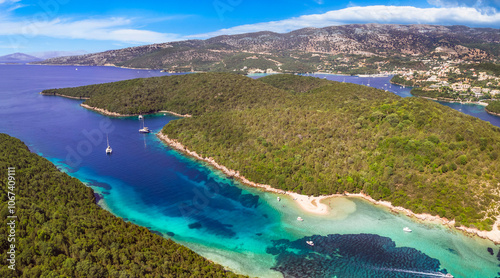 Epirus, Greece. Sivota - stunning aerial drone video of turquoise sea known as Blue Lagoon and unique beach Bella Vraka.