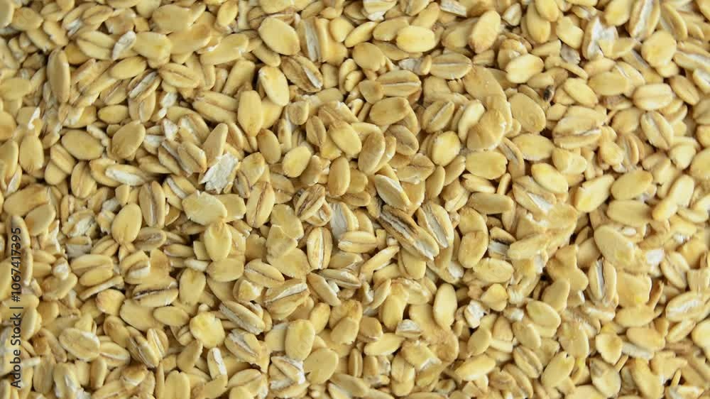 Oatmeal rotates, top view. Slow rotation. Raw rolled oats. Healthy breakfast. Oatmeal rotates, top view. Slow rotation. Raw rolled oats. Healthy breakfast.