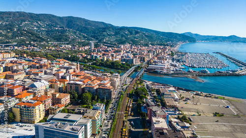 Chiavari, a charming coastal town in Italy's Liguria region, viewed from the air showcases its scenic waterfront, vibrant marina, and historic architecture nestled between the green hills photo