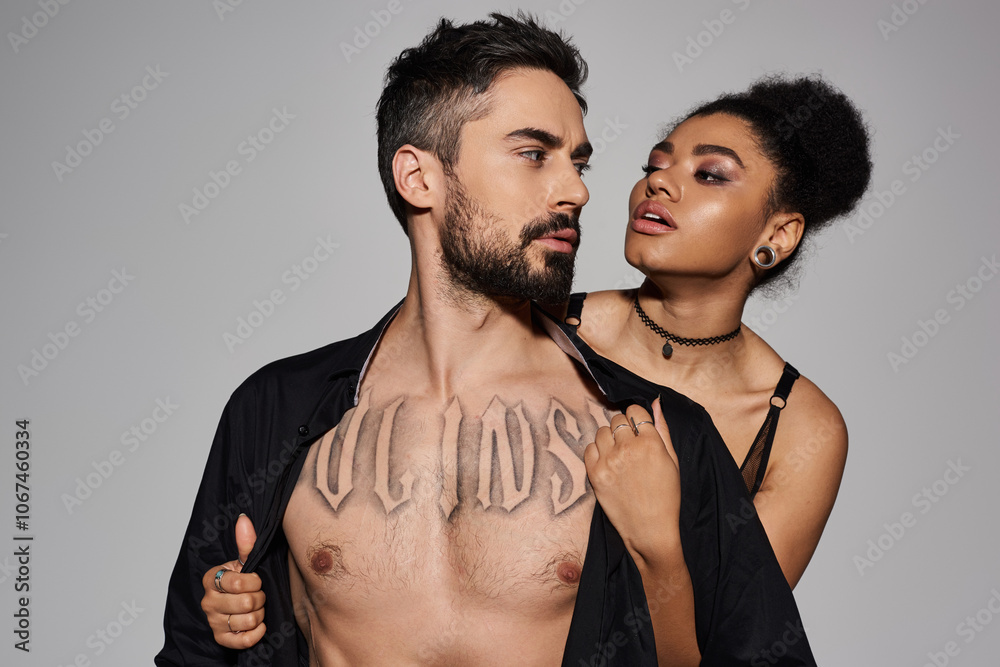 A couple stands close, expressing deep affection, highlighting their connection and allure. A couple stands close, expressing deep affection, highlighting their connection and allure.