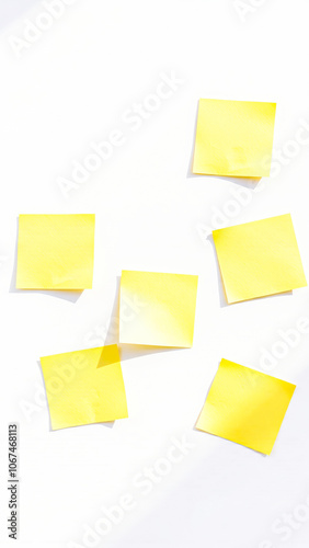 six yellow sticky notes on a white surface