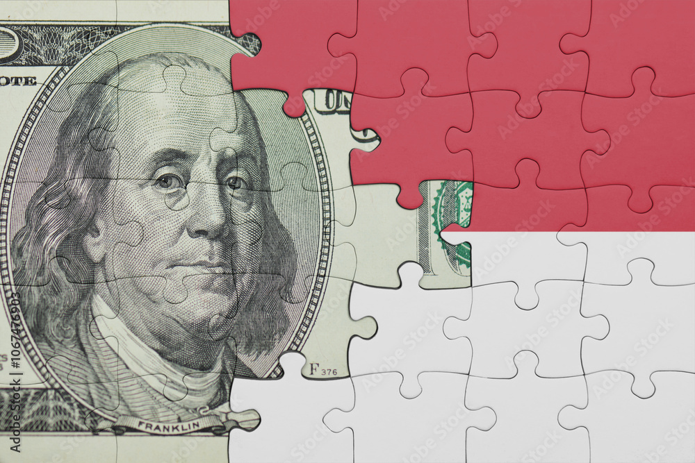 puzzle with the national flag of indonesia and the usa dollar money .finance concept puzzle with the national flag of indonesia and the usa dollar money .finance concept