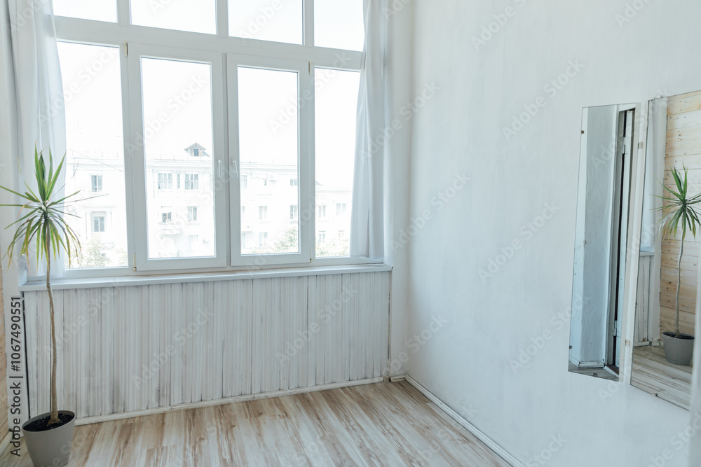 Interior of an empty light gray room with a window Interior of an empty light gray room with a window