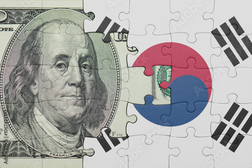 puzzle with the national flag of south korea and the usa dollar money .finance concept