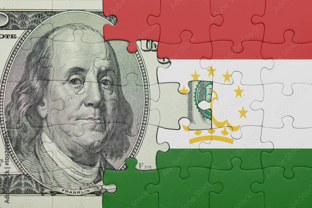 puzzle with the national flag of tajikistan and the usa dollar money .finance concept puzzle with the national flag of tajikistan and the usa dollar money .finance concept