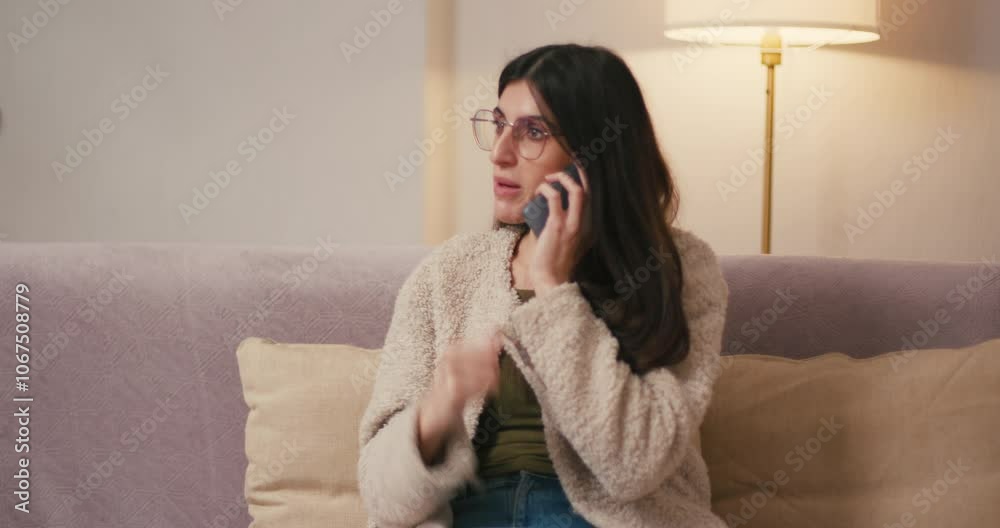 Hispanic woman answers phone call responding with anger Hispanic woman answers phone call responding with anger
