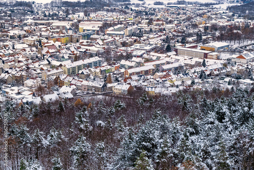 Obraz na płótnie A snowy landscape with a town in the distance. The sky is cloudy and the snow is covering the ground. Germany. w salonie