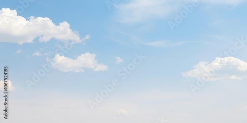 A serene blue sky with fluffy white clouds drifting lazily across the horizon, set against a gentle gradient of pale blue and cream hues, sunny day, weather, clear sky