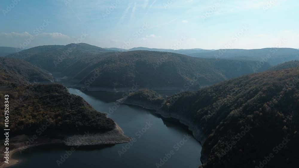 Aerial drone view of the canyon of the river Uvac in southwestern Serbia. A winding river with clear blue water on sunny autumn day. Yellow-green mixed forest from a bird's-eye view Aerial drone view of the canyon of the river Uvac in southwestern Serbia. A winding river with clear blue water on sunny autumn day. Yellow-green mixed forest from a bird's-eye view