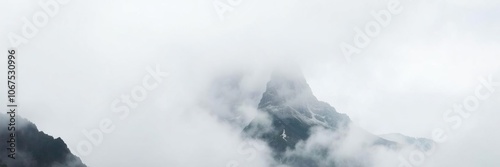 Majestic sharp peak shrouded in fog, creating an ethereal and mysterious atmosphere, misty, atmospheric