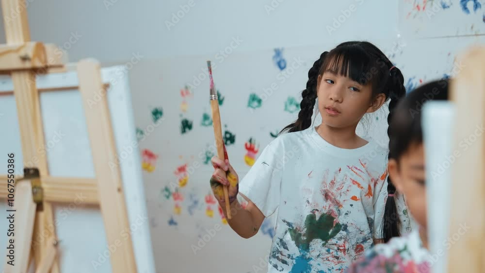 Playful student painted or draw canvas at stained wall with diverse friends in art lesson. Group of happy multicultural children working or create artwork at messy room. Creative activity. Erudition. Playful student painted or draw canvas at stained wall with diverse friends in art lesson. Group of happy multicultural children working or create artwork at messy room. Creative activity. Erudition.