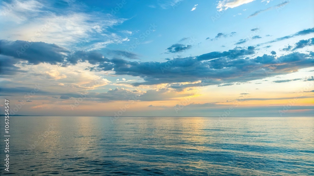 Fototapeta premium Soft focus of a serene summer evening with a vast expanse of sea and sky in shades of blue and gold light, gentle waves, summer