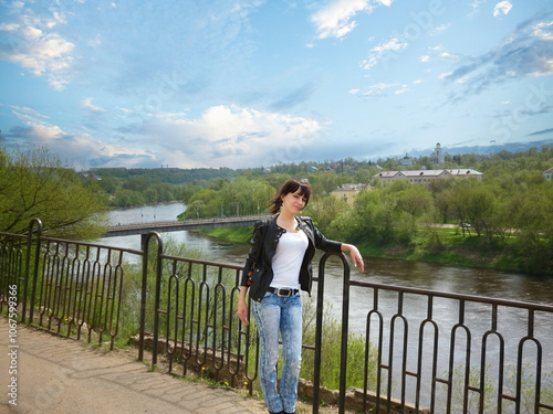 Stunning Young Woman Strikes a Pose Against Urban Backdrop.