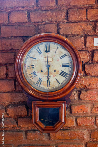 old wall clock in a brick wall