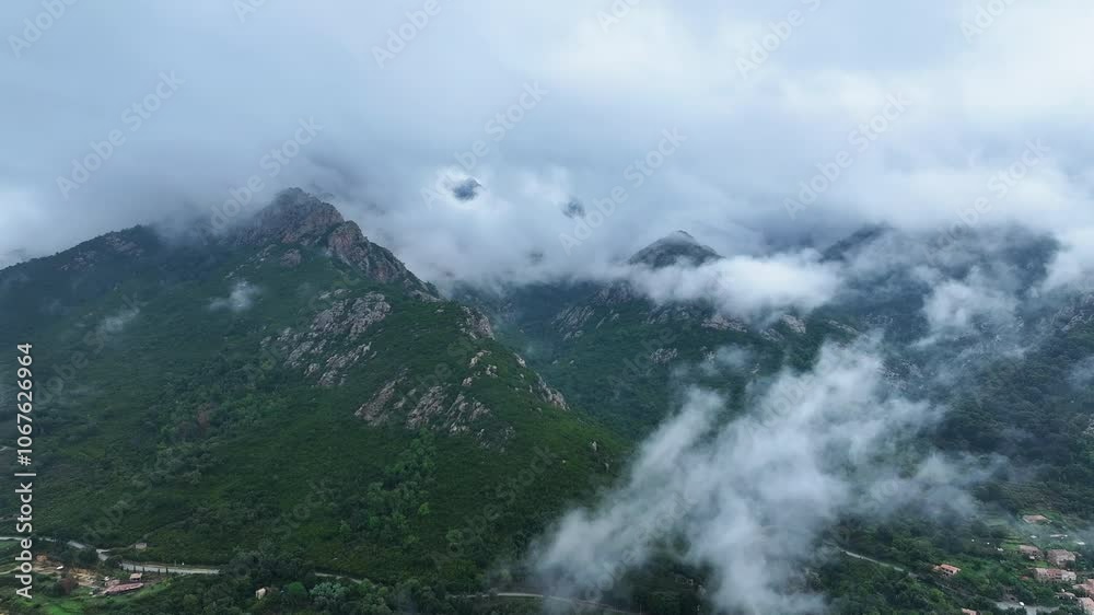 Cloud-covered mountains in a serene landscape showcasing nature's beauty at dawn with mist enveloping the peaks and valleys Cloud-covered mountains in a serene landscape showcasing nature's beauty at dawn with mist enveloping the peaks and valleys
