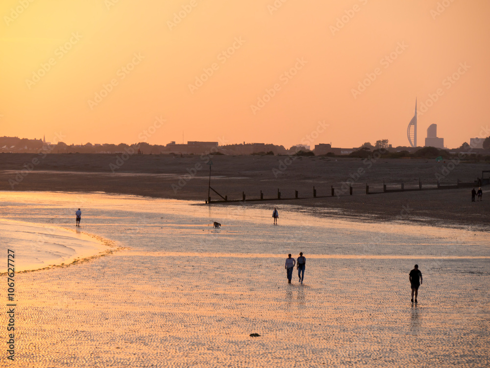 Beach at south end of Hayling island is turned golden by sunset