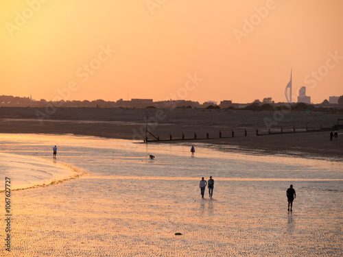 Beach at south end of Hayling island is turned golden by sunset photo