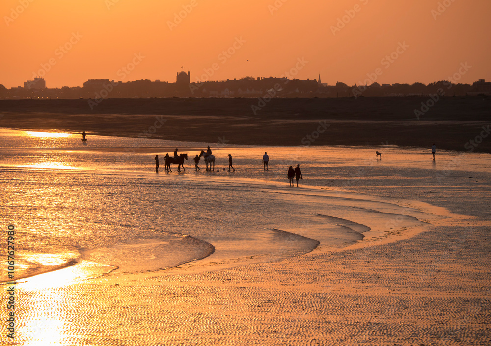 Beach at south end of Hayling island is turned golden by sunset