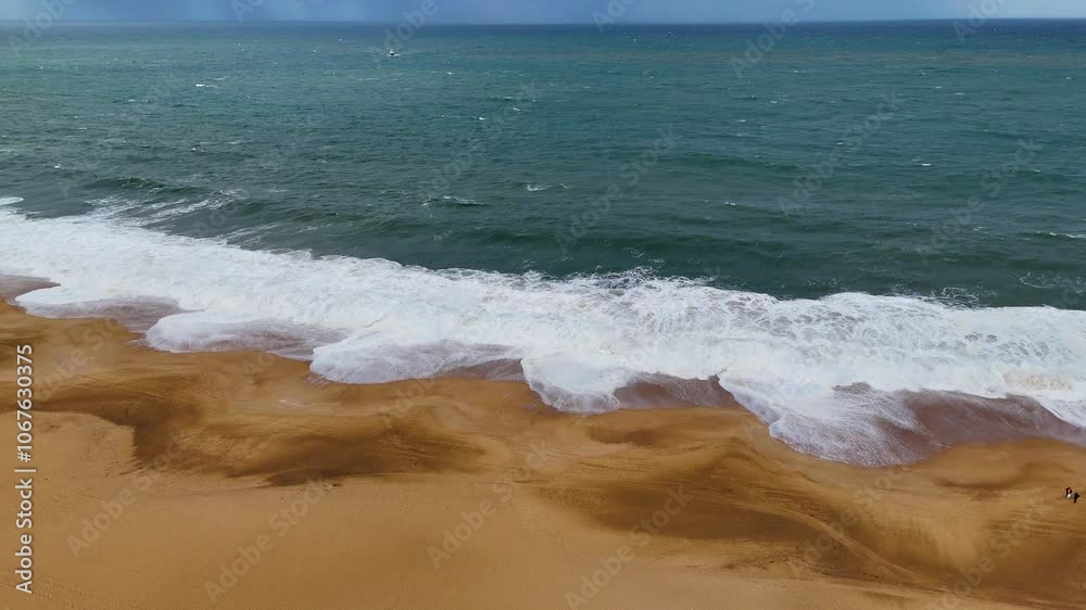 Breaking waves at Nazare beach on the Portugal coastal town on the Atlantic ocean shore. Aerial 4K drone video footage Breaking waves at Nazare beach on the Portugal coastal town on the Atlantic ocean shore. Aerial 4K drone video footage