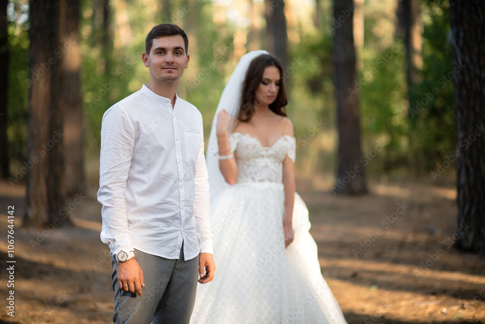 Young white sexy man with bride in the background Young white sexy man with bride in the background