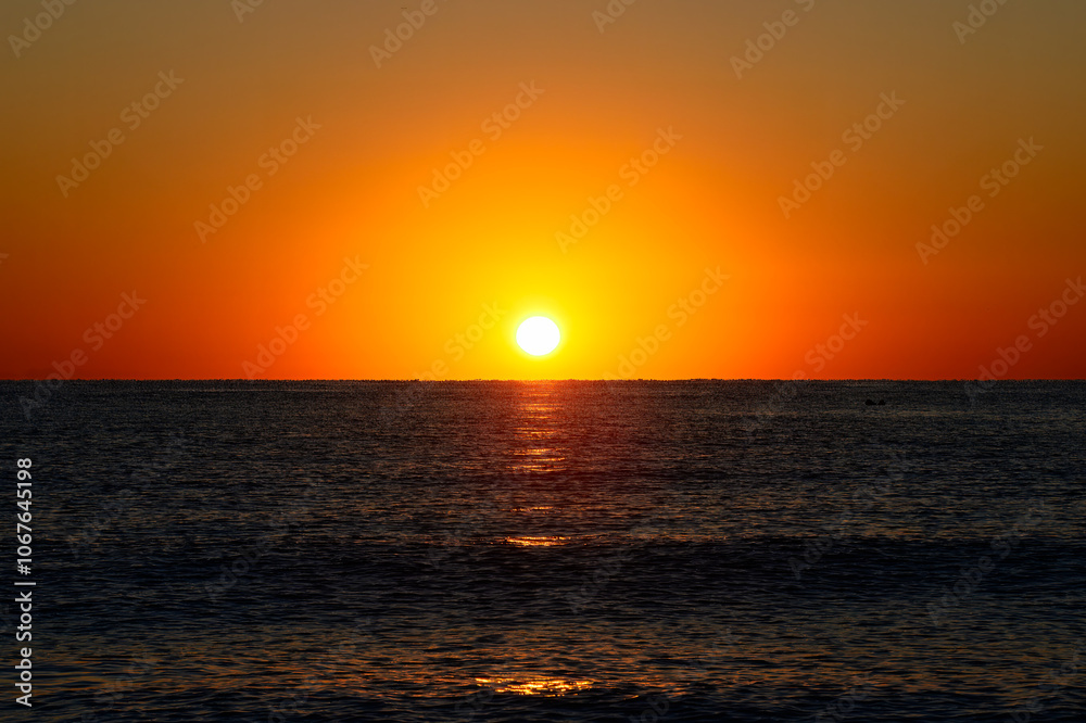 Vibrant Sunset Over Calm Ocean Horizon. A vibrant sunset with a glowing orange sky over a calm ocean horizon, capturing a serene and tranquil seascape.
Vibrant Sunset Over Calm Ocean Horizon. A vibrant sunset with a glowing orange sky over a calm ocean horizon, capturing a serene and tranquil seascape.