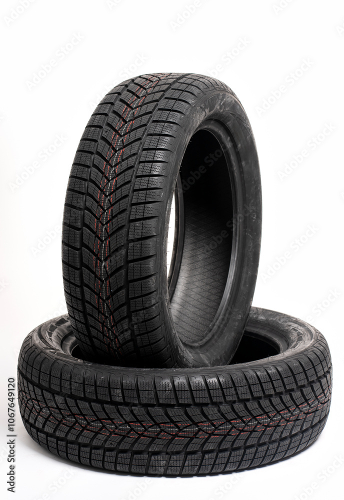 Two winter tires standing on white background in studio Two winter tires standing on white background in studio