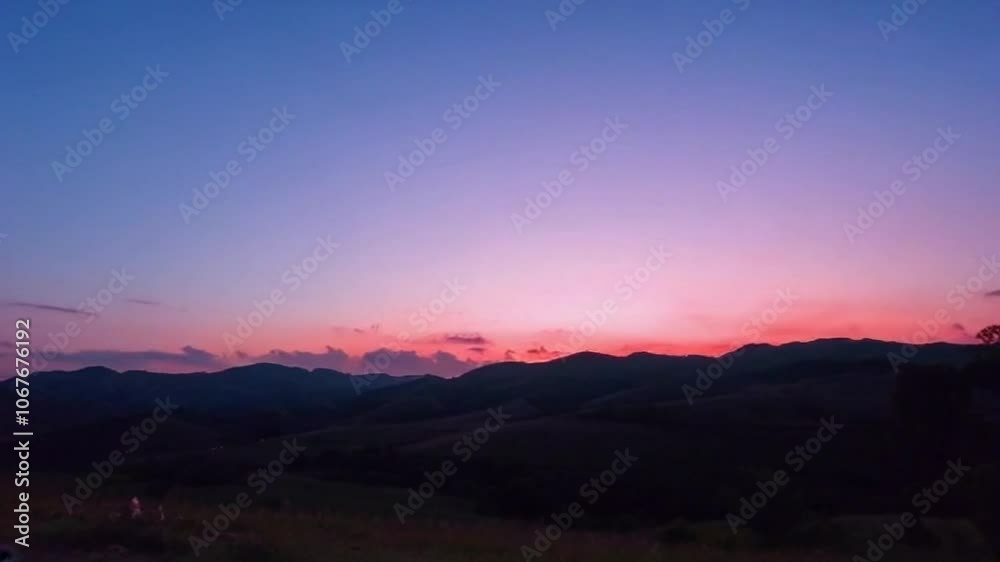 4K Video of Rolling Hills Stretching into the Distance Under a Pink and Orange Sunset Sky