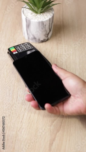 Customer using smartphone to make nfc payment