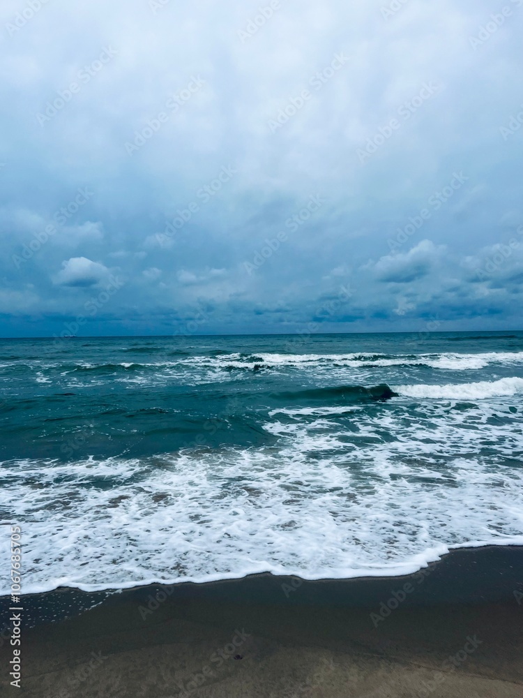 cloudy grey seascape, waved sea horizon, windy at the sea, empty beach cloudy grey seascape, waved sea horizon, windy at the sea, empty beach