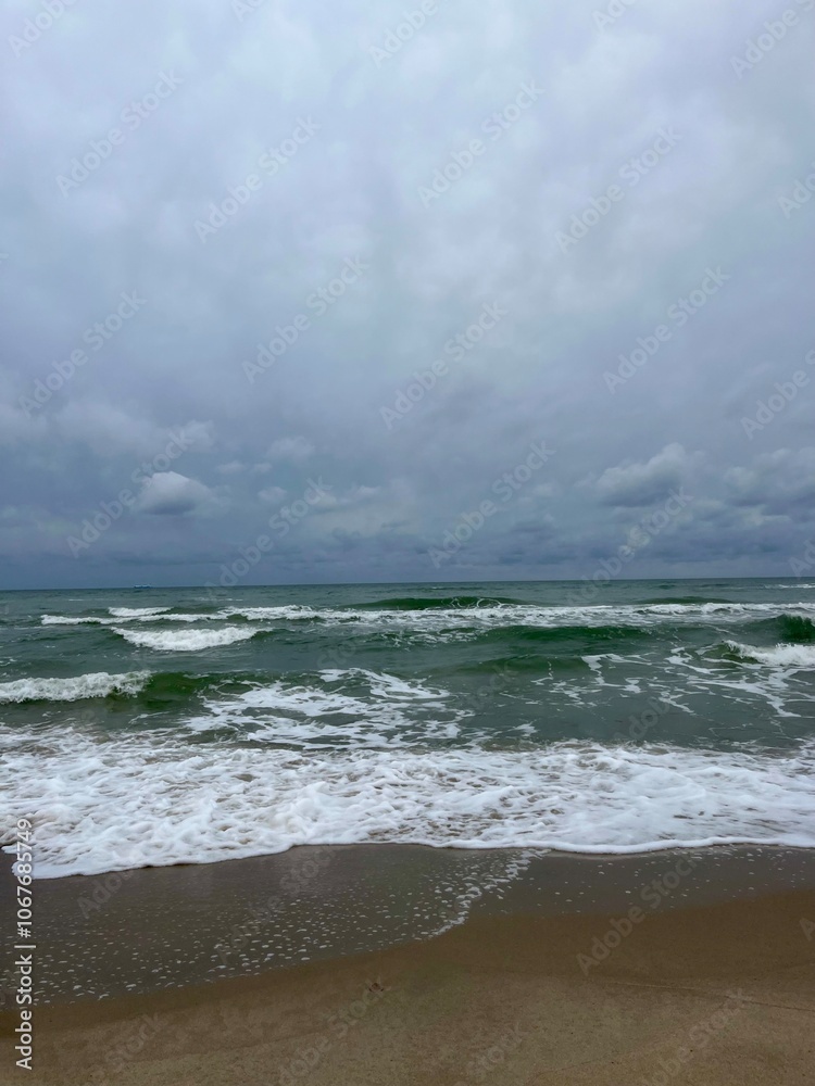 cloudy grey seascape, waved sea horizon, windy at the sea, empty beach cloudy grey seascape, waved sea horizon, windy at the sea, empty beach