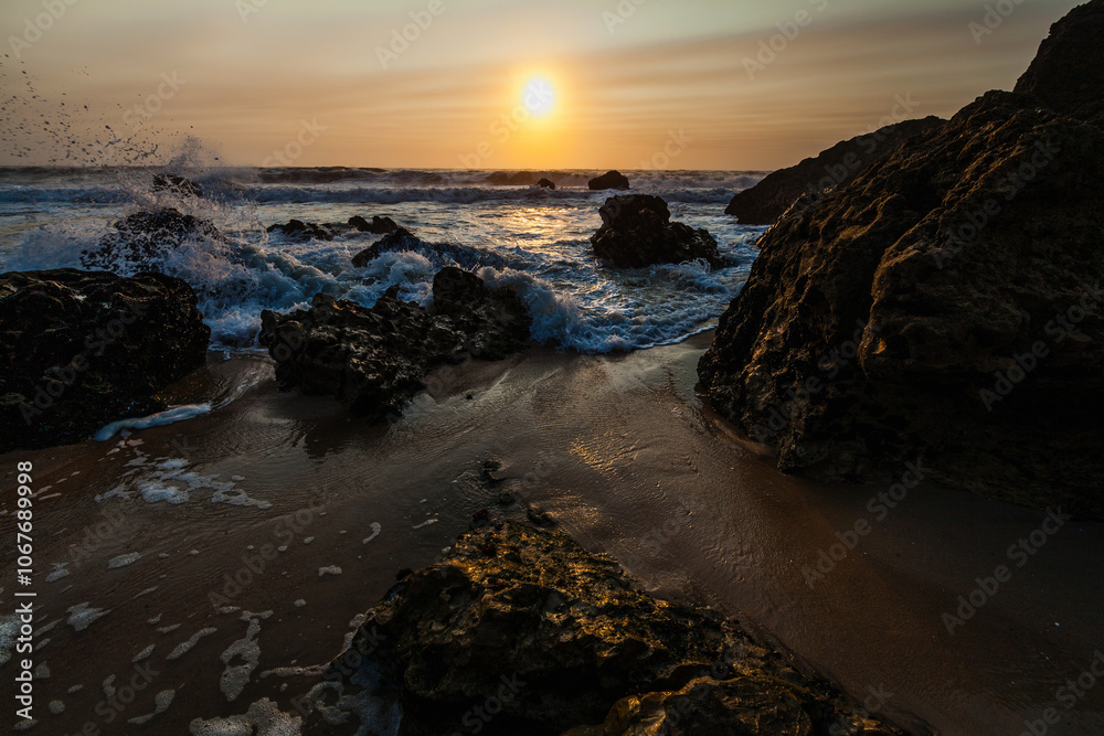 coastal sunset scene, waves rush in from the open sea, filling the space between the dark, rugged rocks coastal sunset scene, waves rush in from the open sea, filling the space between the dark, rugged rocks