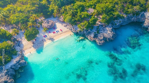 Aerial view of a tropical beach with clear turquoise waters and lush greenery.