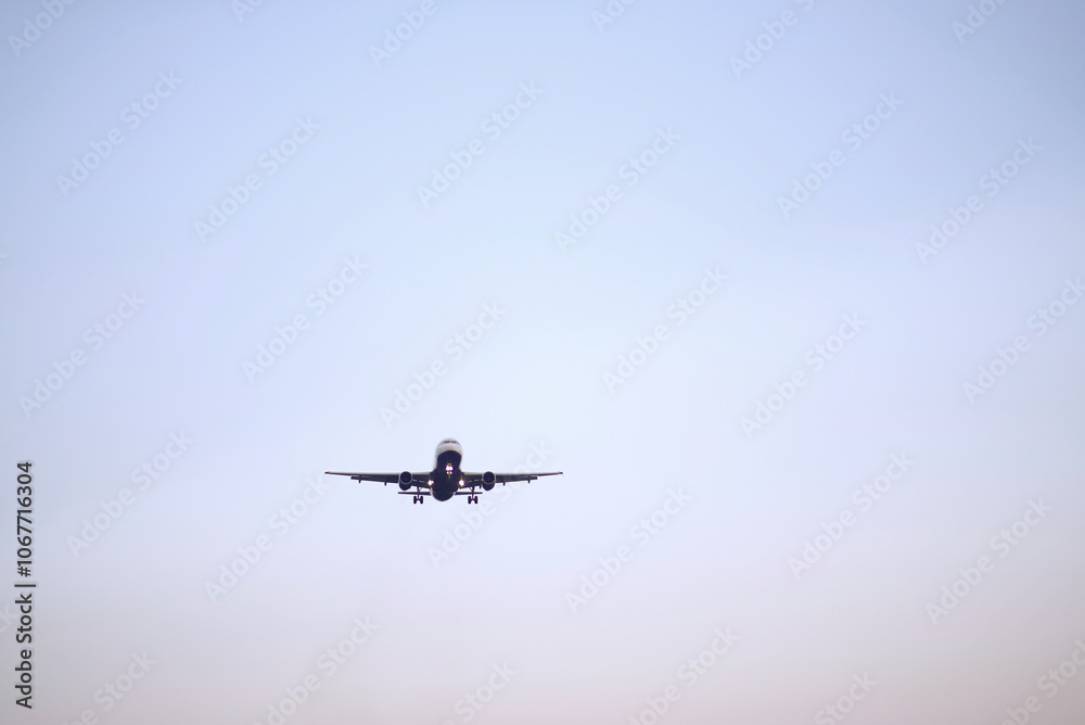 Passenger Airplane Landing Take-Off at Dawn with Clear Sky Background Passenger Airplane Landing Take-Off at Dawn with Clear Sky Background