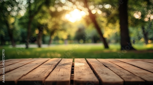 Empty wooden table top with a blurred green park background for product display montage, a summer concept.