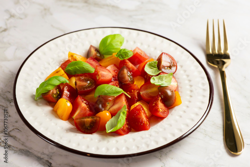 Salad with halves of red and yellow tomatoes cherry with basil