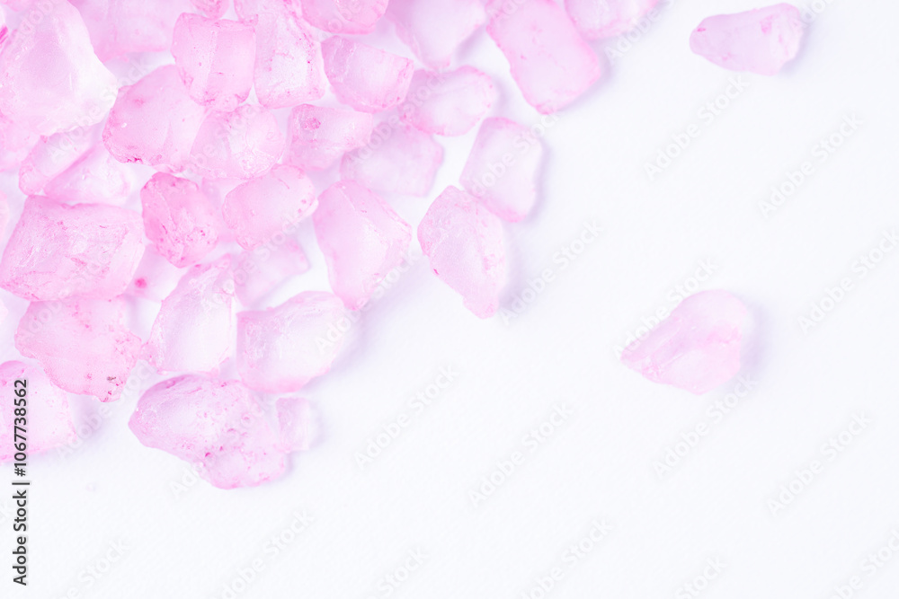 Pink bath salt on white background, macro Pink bath salt on white background, macro