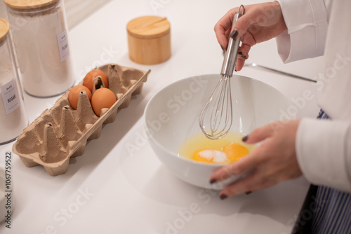 Woman at home in her kitchen cooking, woman hands, culinary blog, step-by-step recipe for cooking a dish, breakfast , recipe, plate and whisk for preparing breakfast