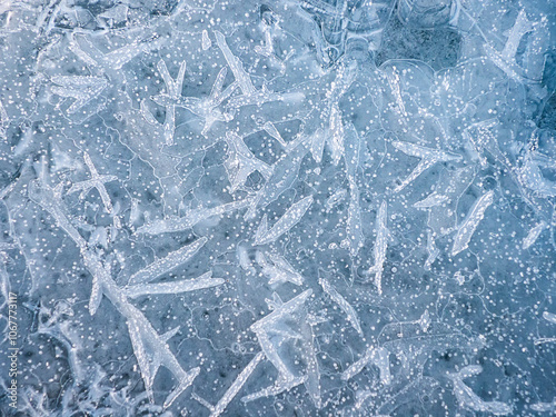ice texture on the lake water in winter outdoors with snow