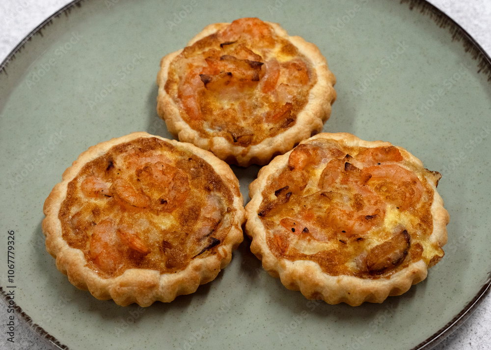 Seafood and bakery. Closeup view of three shrimp pies with gratin cheese Seafood and bakery. Closeup view of three shrimp pies with gratin cheese