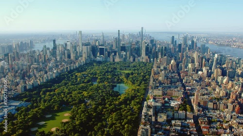 Aerial Helicopter Footage Over Central Park with Nature, Trees. Manhattan Skyscrapers Cityscape. Midtown New York City Beautiful Sunny Day