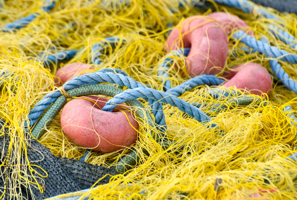 Fishing net with yellow, blue and red colors, closeup Fishing net with yellow, blue and red colors, closeup