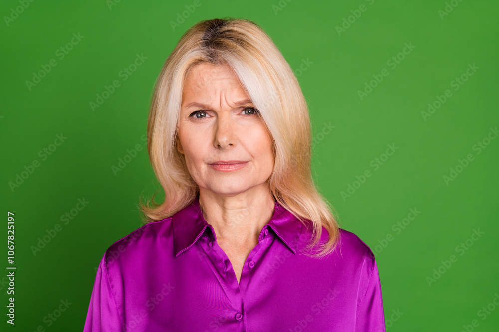 Photo portrait of lovely pensioner lady look skeptical camera dressed stylish purple satin garment isolated on green color background Photo portrait of lovely pensioner lady look skeptical camera dressed stylish purple satin garment isolated on green color background