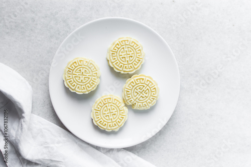 Overhead view of tuwon madara on a white plate, nigerian alawar madara milk candy, top view of milk fudge on a white ceramic plate photo