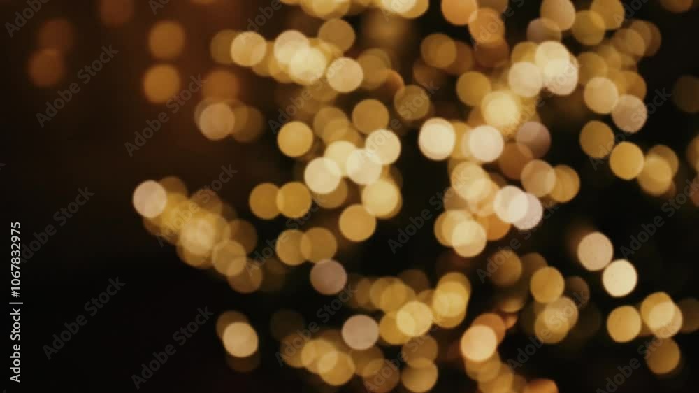 Golden bokeh background.Christmas and New Year background. Glowing holiday wallpaper in warm gold and brown tones. 4k footage