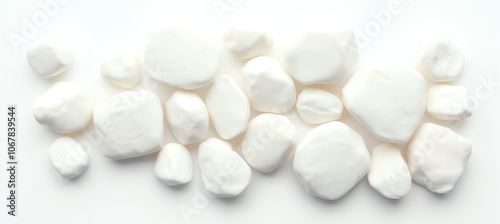 collection of smooth, white pebbles arranged on a clean white background, showcasing a minimalist aesthetic ideal for various decorative uses