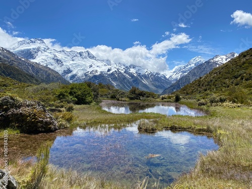 Hill top views of Aoraki Mount Cook reflecting in water at Red Tarns, Mount Cook National Park, New Zealand. Landscape with lake and mountains