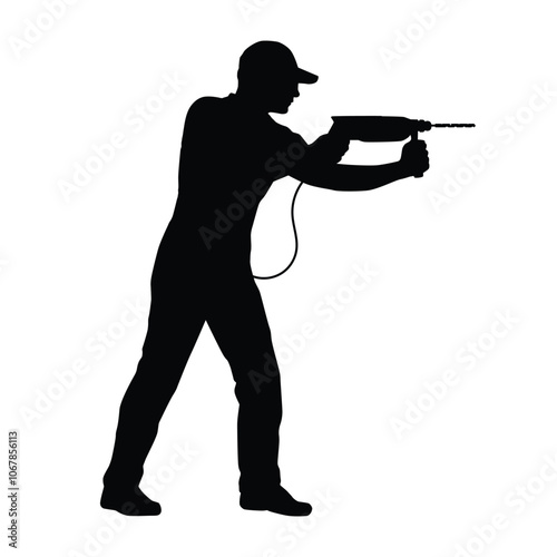 Silhouette of a worker using an electric drill
