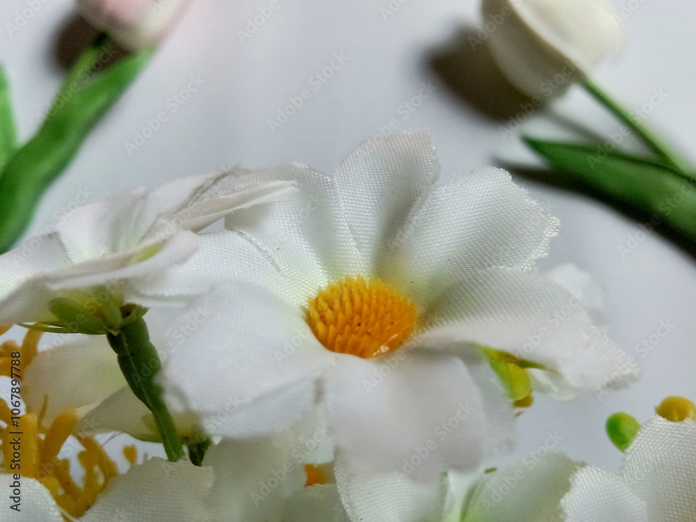 Obraz premium Artificial decorative flowers on white background.