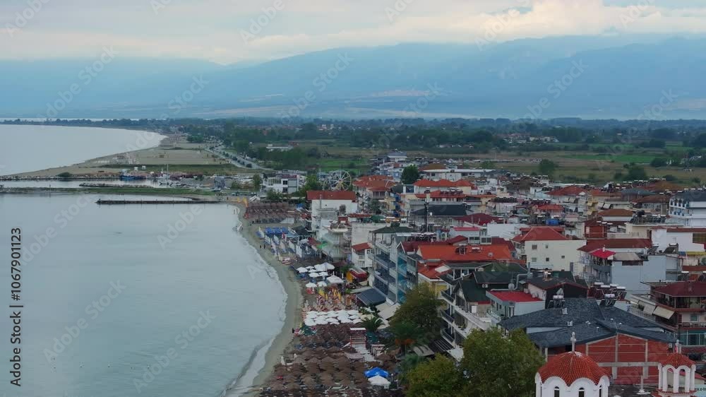 Camera slowly pans over the greek city of Paralia Katerinis showing the beach, hotels, and restaurants along the Aegean Sea Camera slowly pans over the greek city of Paralia Katerinis showing the beach, hotels, and restaurants along the Aegean Sea
